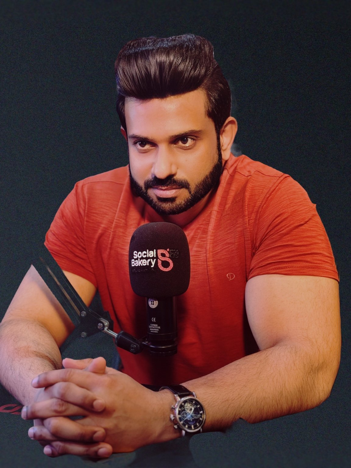 Asif Tourab at a podcast microphone